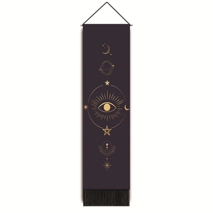 Macro detail of mystical moon and eye gold foil pattern on purple tapestry with fringe