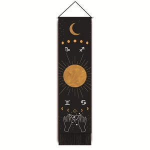 Close-up of black celestial tapestry with gold zodiac symbols and elegant tassels