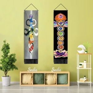 Detailed view of long hanging tapestries with snakes and chakras on a green wall