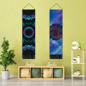 Vertical mandala tapestries with tassels hanging above a wooden cabinet in a cozy room