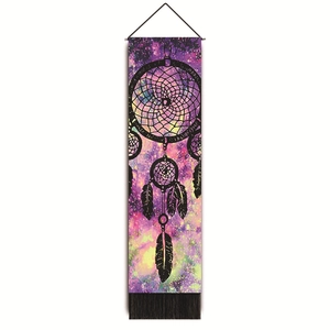 Detail of dreamcatcher tapestry with black tassels and vibrant nebula galaxy background