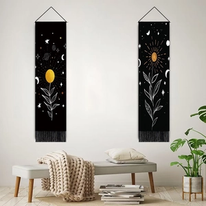 Modern Nordic wall tapestries with celestial motifs and tassels in a minimalist room