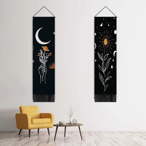 Bohemian style wall tapestries with sun and moon patterns on black fabric with tassels