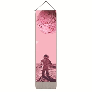 Detailed view of pink astronaut wall scroll with planets, black hanging cord and tassels