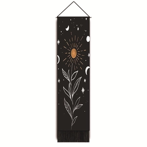 Detail of bohemian tapestry with gold sun and moon prints over a black background