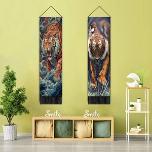 Detail of hanging wall tapestry featuring artistic tiger prints and black fringe accents