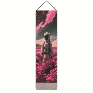 Detail of pink astronaut tapestry with surreal flower field print and black hanging cord