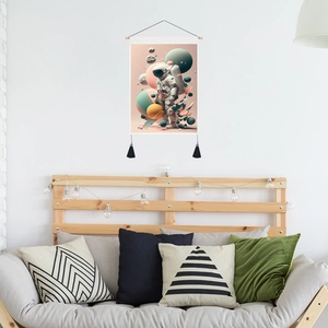 Astronaut tapestry wall art with pink cosmic illustration and black decorative tassels
