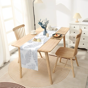 Tropical leaf print table runner in white and grey for minimalist dining room decor