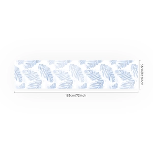 Linen table runner with blue tropical leaf prints measuring 33x183cm for dining decor