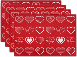 Detailed stack of linen placemats with red heart patterns for Valentine's table decor