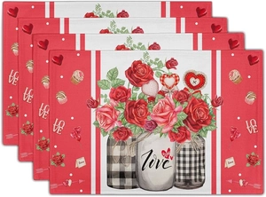 Set of four stacked Valentine's linen placemats with red roses and love motifs