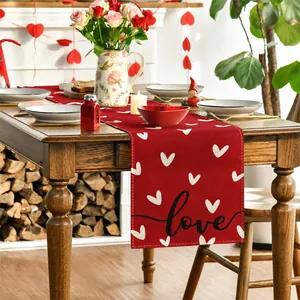 Detail of red Valentine linen table runner with white hearts and black love lettering