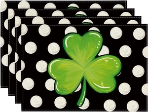 Detail of four linen St. Patrick's Day placemats with shamrocks on polka dot background