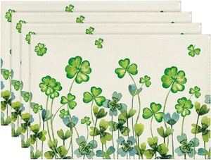 Detailed view of layered St. Patrick's Day linen placemats with green shamrock pattern