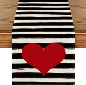 Close-up of heart print on black and white striped linen table runner for home decor