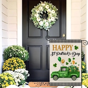Close-up of linen St. Patrick's Day garden flag featuring a green truck and shamrocks