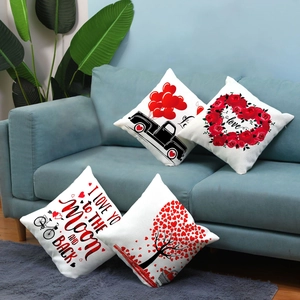 Set of four red Valentine's Day plush pillow covers with heart motifs on a sofa