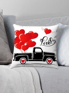 Macro detail of plush pillowcase featuring a red heart truck and Love script on a sofa