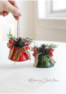 Detailed view of red and green metal Christmas bells with pine cones and burlap bows
