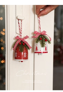 Detail of Christmas bell hangers with plaid bows, pine needles, and red berries