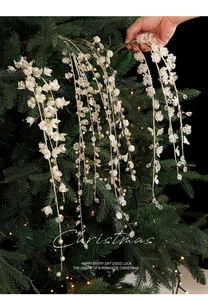 Detail of white ivory Christmas tree branch picks with pearls and crystal beads decor