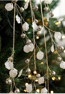 Detail of Christmas tree spray with pearlescent petals and silver beads on gold wire