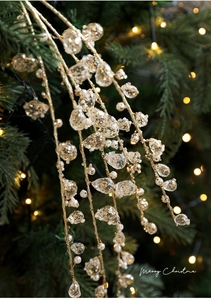 Close-up of golden Christmas branch with sparkling glitter beads and crystal teardrop pendants