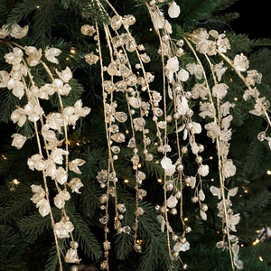 Sparkling Christmas pick with white beads and glitter petals on green tree branch