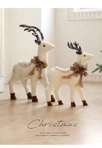 Pair of white plush Christmas reindeer decorations with burlap bows and pinecone accents
