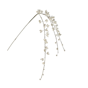 White acrylic Christmas tree branch with glitter and faux pearls on a minimalist background