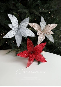 Detail of red and silver Christmas poinsettia flowers with glitter on Xmas tree