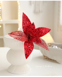 Close-up of red sequined artificial poinsettia flower for Christmas tree decor