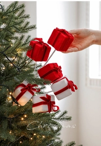 Detail of red and white velvet Christmas gift box picks for festive tree decoration