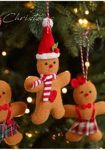 Detail of assorted plush gingerbread man Christmas tree ornaments with festive hanging ropes