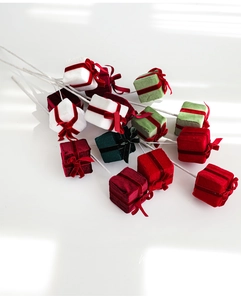 Close-up of velvet Christmas gift box picks in red green and white for floral decor