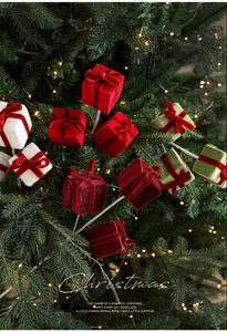 Velvet Christmas gift box floral picks in red and white on a festive tree branch