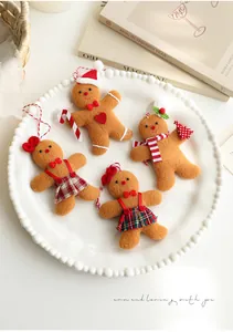 Set of four plush gingerbread man ornaments with plaid skirts and festive hats on a plate