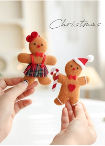 Detail of plush gingerbread man and woman ornaments for Christmas tree hanging decoration