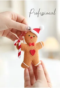 Close-up of a gingerbread man felt ornament with a candy cane and festive red details