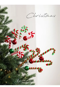 Close-up of red and green spiral candy cane picks with metallic ornaments on Christmas tree