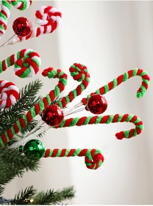 Close-up of plush candy cane and glitter ball picks for Christmas tree decoration