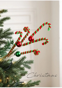 Macro detail of red and green swirl lollipop picks and ornaments on a Christmas tree