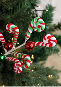 Detail of plush candy and gingerbread picks with spiral patterns on a Christmas tree