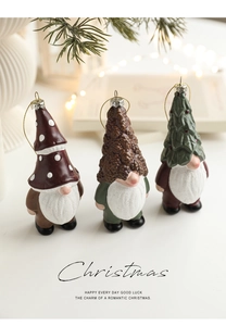 Close-up of three festive forest gnome ornaments with mushroom and pinecone hats