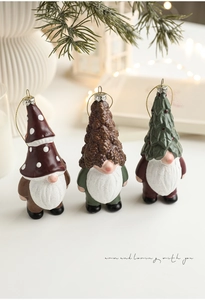 Close-up of three festive Christmas gnomes with mushroom, pinecone, and tree hats