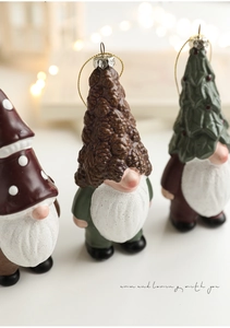Close-up of three festive Christmas gnomes featuring pine cone, mushroom and tree hats