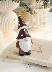 Detail of Christmas gnome ornament with polka dot hat and white beard on a book