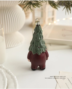 Detail of Santa Claus Christmas tree ornament with golden cord on a festive background