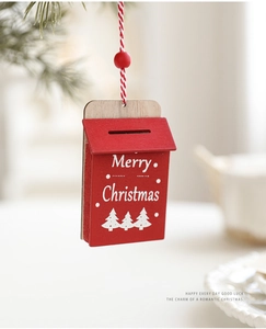 Detail of red wooden mailbox Christmas ornament with white Merry Christmas text and red bead